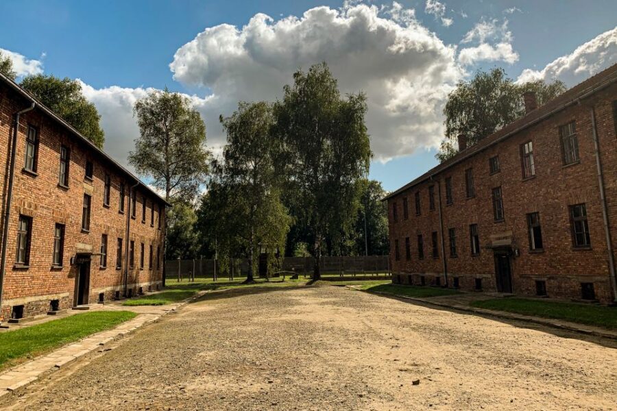 From Krakow: Auschwitz-Birkenau Memorial and Museum Tour - Entering Auschwitz I: Dormitories, Exhibitions, and the System Close Up