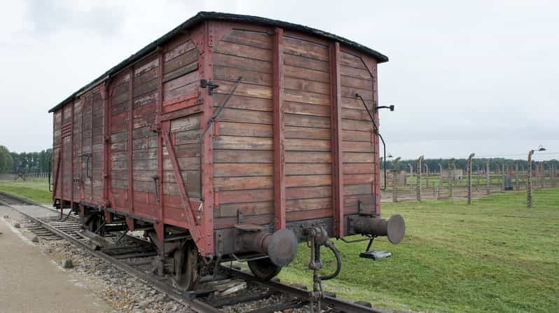 From Krakow: Wieliczka Salt Mine & Auschwitz Guided Trip - Auschwitz II-Birkenau: the railway, barracks, and gas chamber ruins