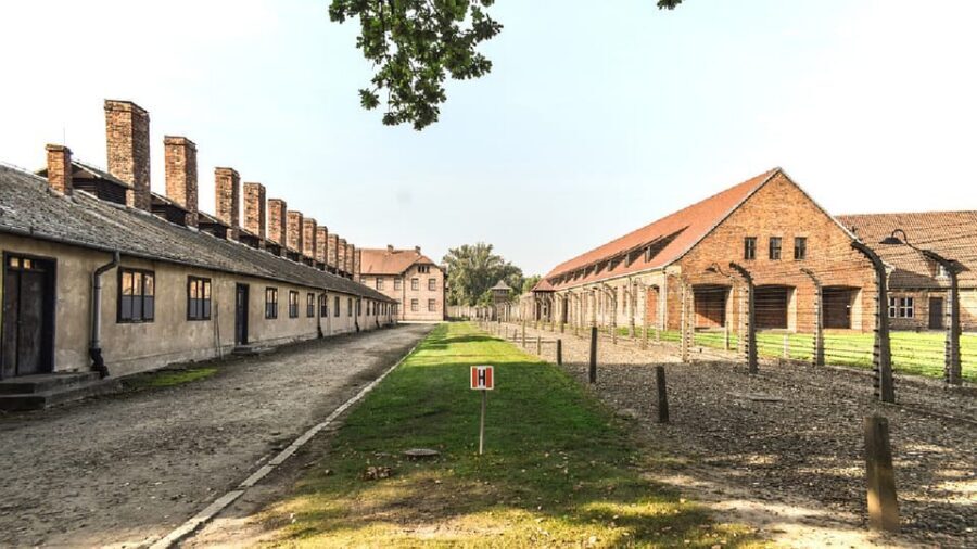 From Krakow: Wieliczka Salt Mine & Auschwitz Guided Trip - Entering Auschwitz I with clear audio and guided context
