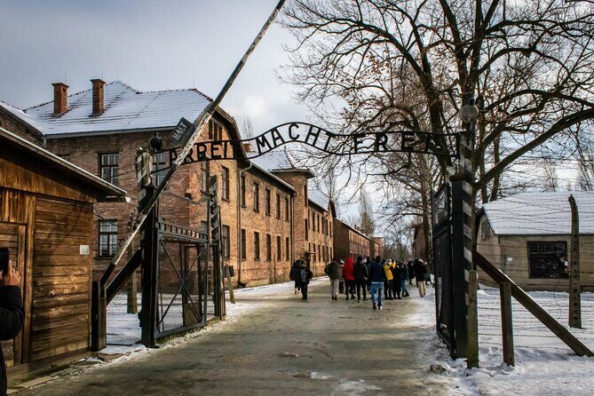 Krakow: Auschwitz-Birkenau Guided Tour with Ticket and Transfer - The Auschwitz I experience: walking the gate line with context