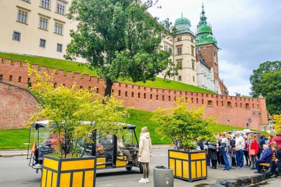 Krakow: City Golf Cart Tour and Schindler's Factory Museum - Crossing to Podgórze: Ghetto Wall Fragment, Chair Memorial, and Under the Eagle Pharmacy